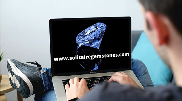 laptop screen with huge real diamond on black background promoting solitairegemstones.com domain name is available to purchase